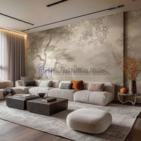 A bright, modern living room featuring a soft, vintage watercolor tree landscape mural wallpaper behind a plush cream modular sofa and dark coffee tables