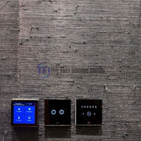 A close-up interior shot of a dark charcoal jute wallpaper accent wall featuring installed smart home automation touch control switches and lighting panels