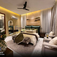 A luxurious modern bedroom featuring a warm minimalist sunset landscape mural wallpaper with a lake and flying birds, installed behind a dark green tufted bed
