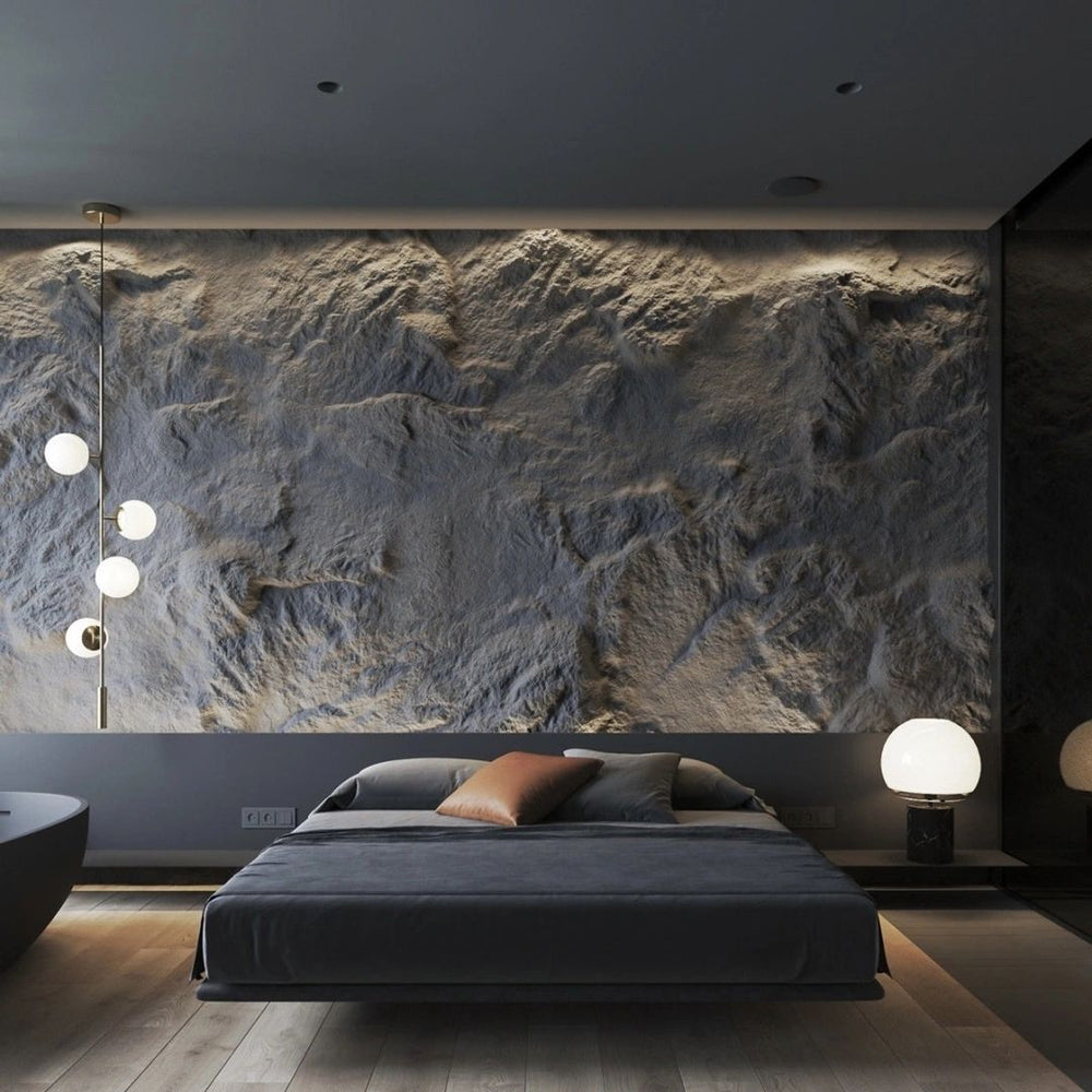 A luxury modern bedroom featuring a deeply textured 3D PU faux stone feature wall serving as a dramatic headboard, illuminated by warm ceiling cove lighting and modern pendant lamps
