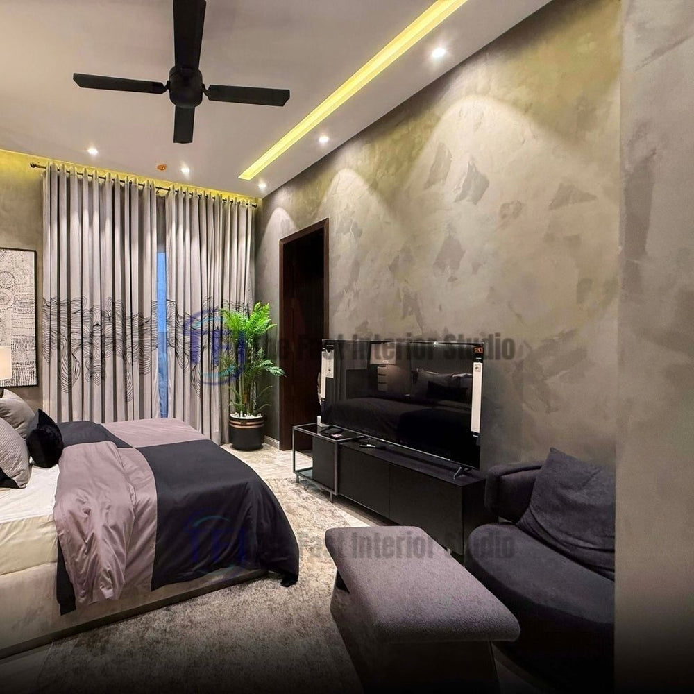 A modern bedroom interior featuring a sophisticated textured metallic plaster finish wall, styled alongside a dark wood media console, black bed, and draped curtains