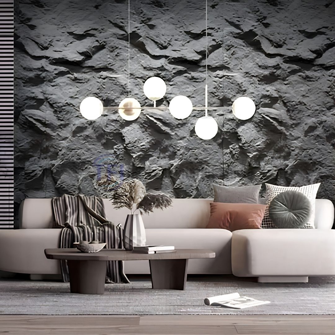 A modern living room featuring a massive dark grey 3D PU cliff rock feature wall behind a white sofa, illuminated by a contemporary globe pendant light