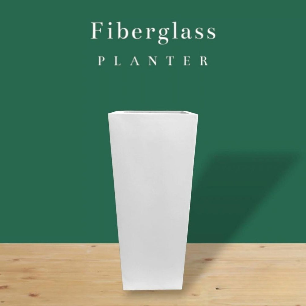 A premium tall, tapered square fiberglass planter in a crisp white finish, styled for luxury indoor and outdoor botanical decor