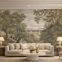 A sophisticated living room featuring a vintage European estate landscape mural wallpaper in muted earthy tones, set behind a classic cream sofa and a round marble table