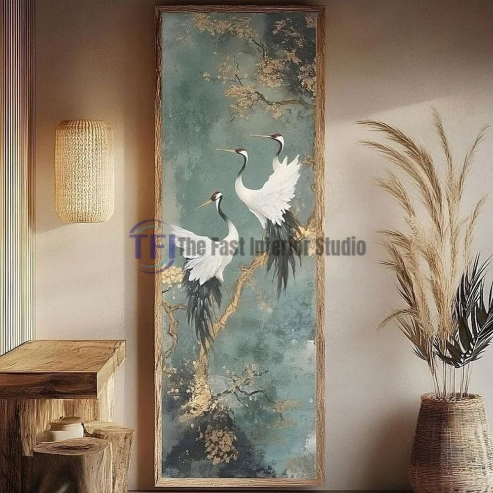 A tall vertical framed mural artwork featuring elegant white cranes and golden branches on a textured teal background, styled elegantly next to a natural wooden console