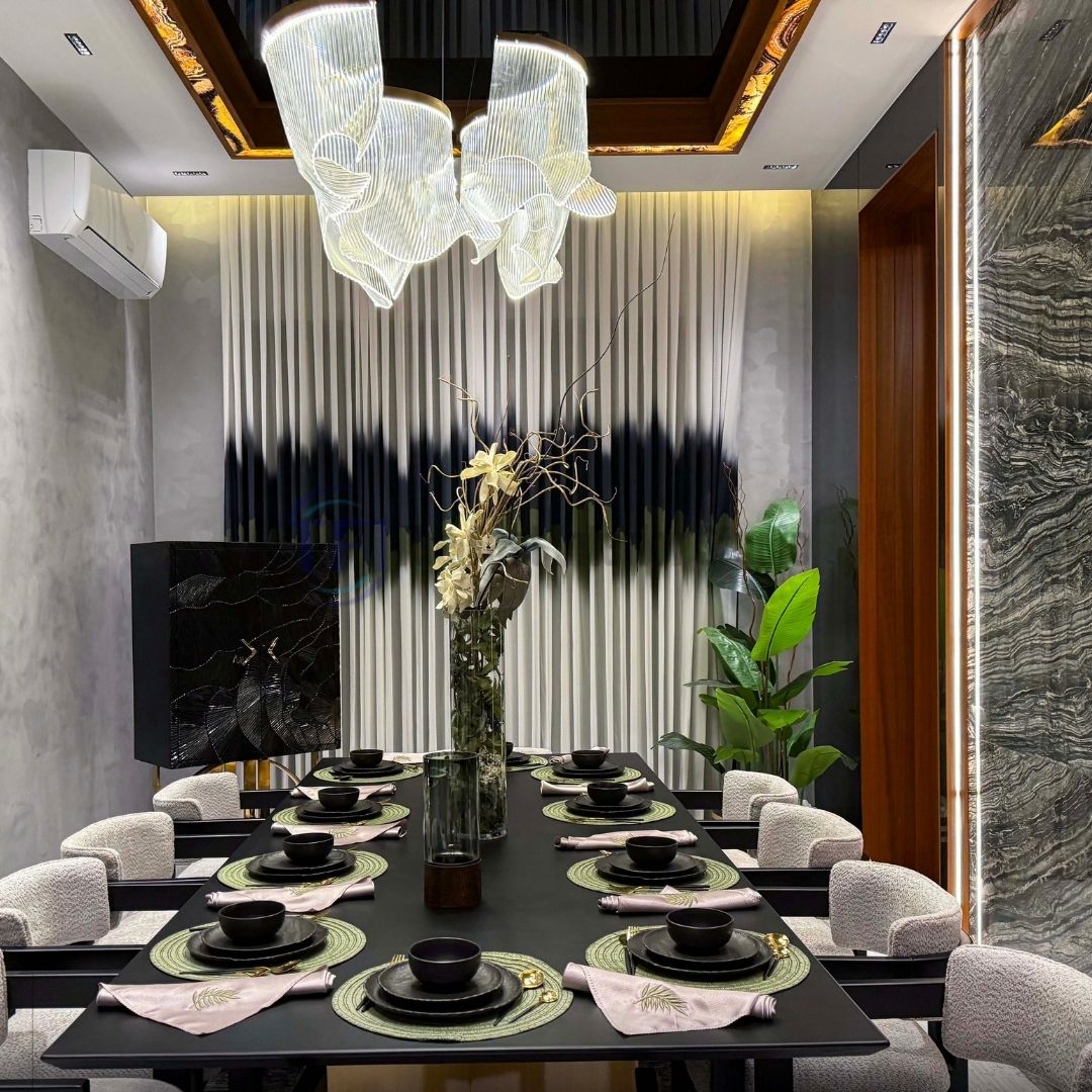 Abstract black and green banded curtains behind a formal black dining table setup