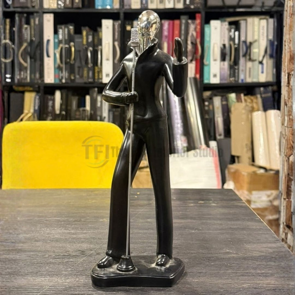 Abstract vocalist statue standing on a desk with a blurred studio background
