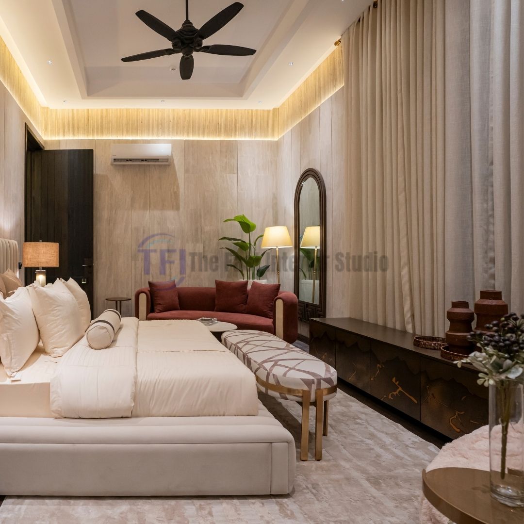 Beige floor-to-ceiling curtains in a modern bedroom with a maroon sofa