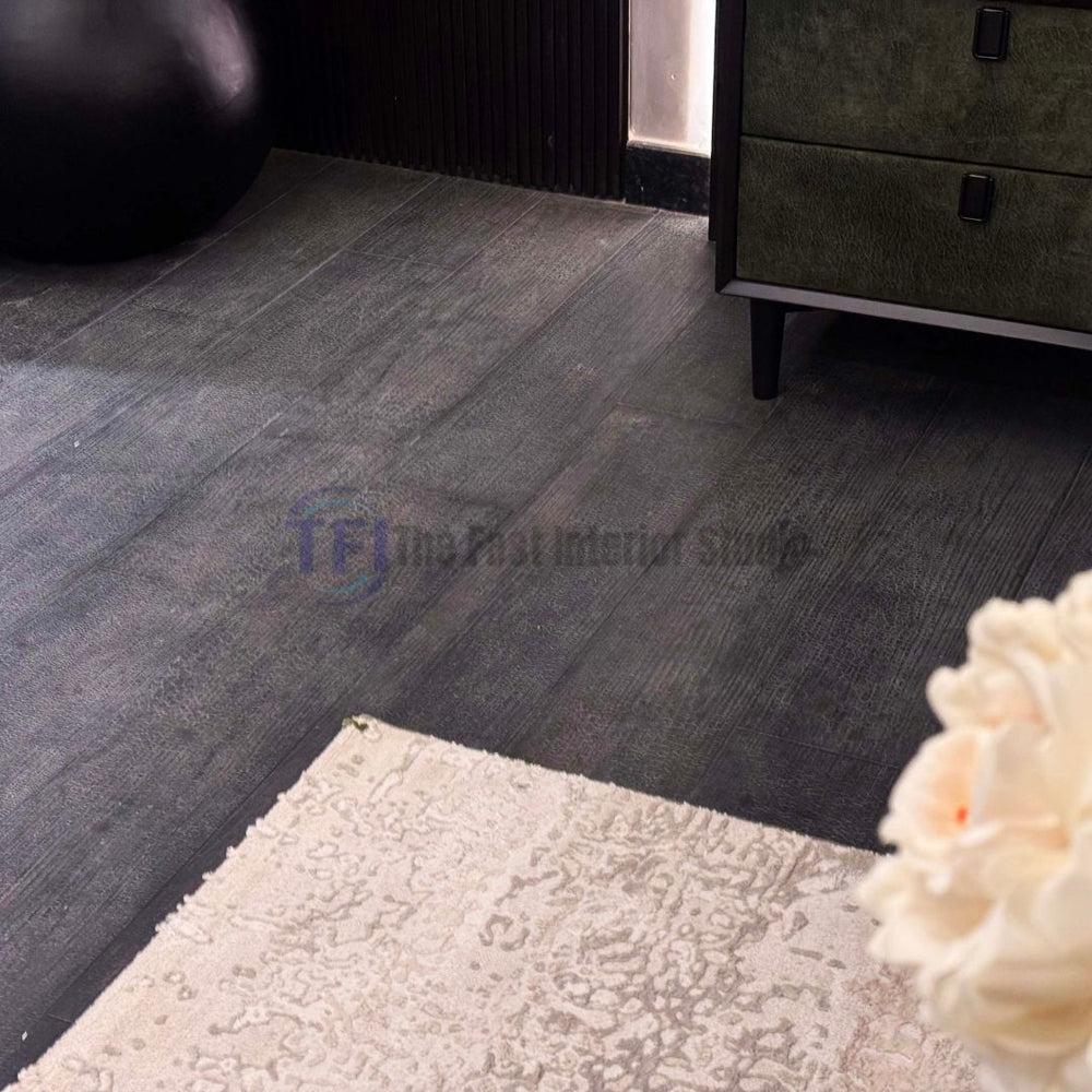 Close-up of premium AGT dark wood laminate planks featuring a highly textured, distressed and crackled surface finish
