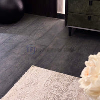 Close-up of premium AGT dark wood laminate planks featuring a highly textured, distressed and crackled surface finish
