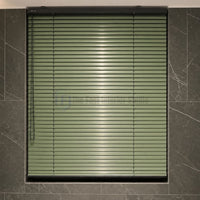 Close up of trending sage green Venetian blinds against dark marble wall