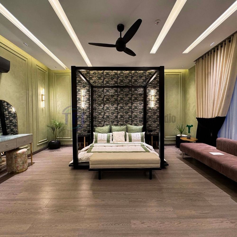 Expansive master bedroom grounded by premium AGT grey wood laminate flooring, featuring a large black canopy bed and green paneled walls