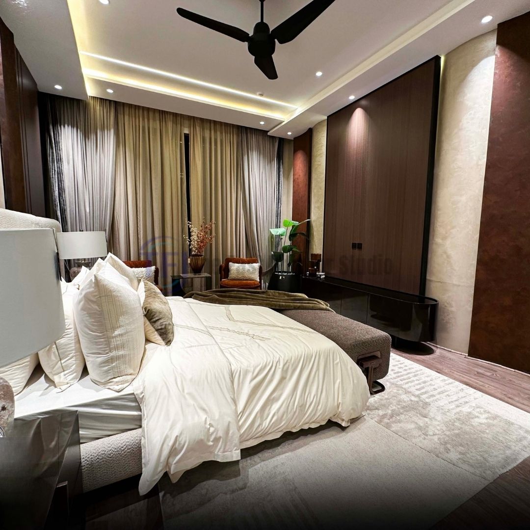 Floor-to-ceiling beige curtains beside dark wood wall paneling in a master bedroom