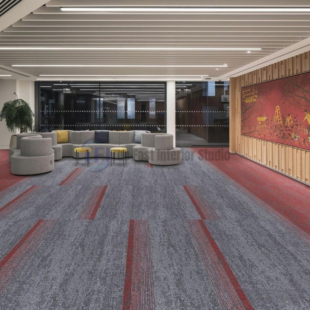 Grey and red accent patterned carpet tiles in a contemporary corporate lounge and seating area
