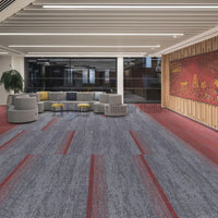 Grey and red accent patterned carpet tiles in a contemporary corporate lounge and seating area