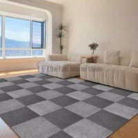 Grey and white checkerboard patterned carpet tiles installed in a modern living room featuring cream sofas in Lahore