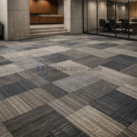 Mixed charcoal and grey checkerboard pattern carpet tiles installed in a professional corporate environment | The Fast Interior Studio