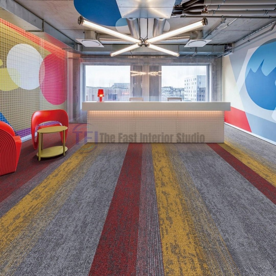 Modular carpet tiles featuring striking red, yellow, and grey vertical stripes in a contemporary creative office reception