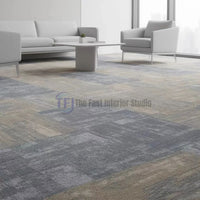 Multi-tone grey and beige patterned carpet tiles in a bright modern corporate reception or sitting area