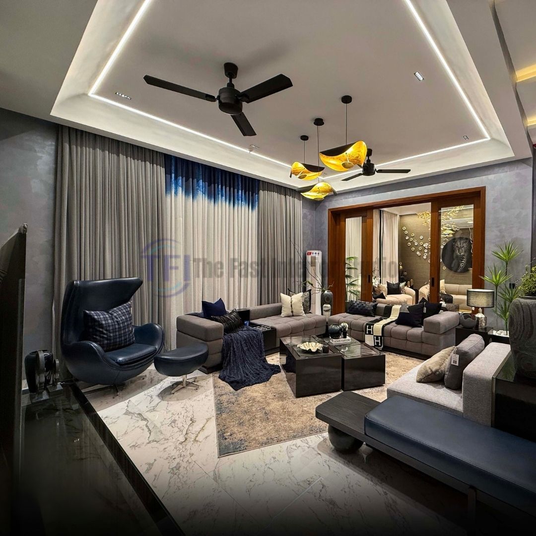 Pleated grey and blue ombre curtains in a modern living room with a blue leather armchair