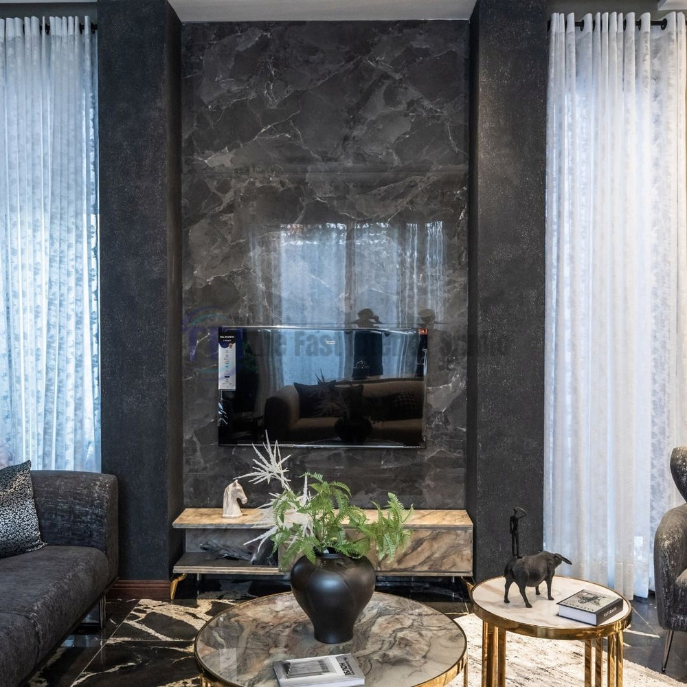 Sheer white curtains beside a dark marble living room media wall