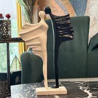 The best modern abstract black and white couple sculpture displayed on a black marble table in a living room