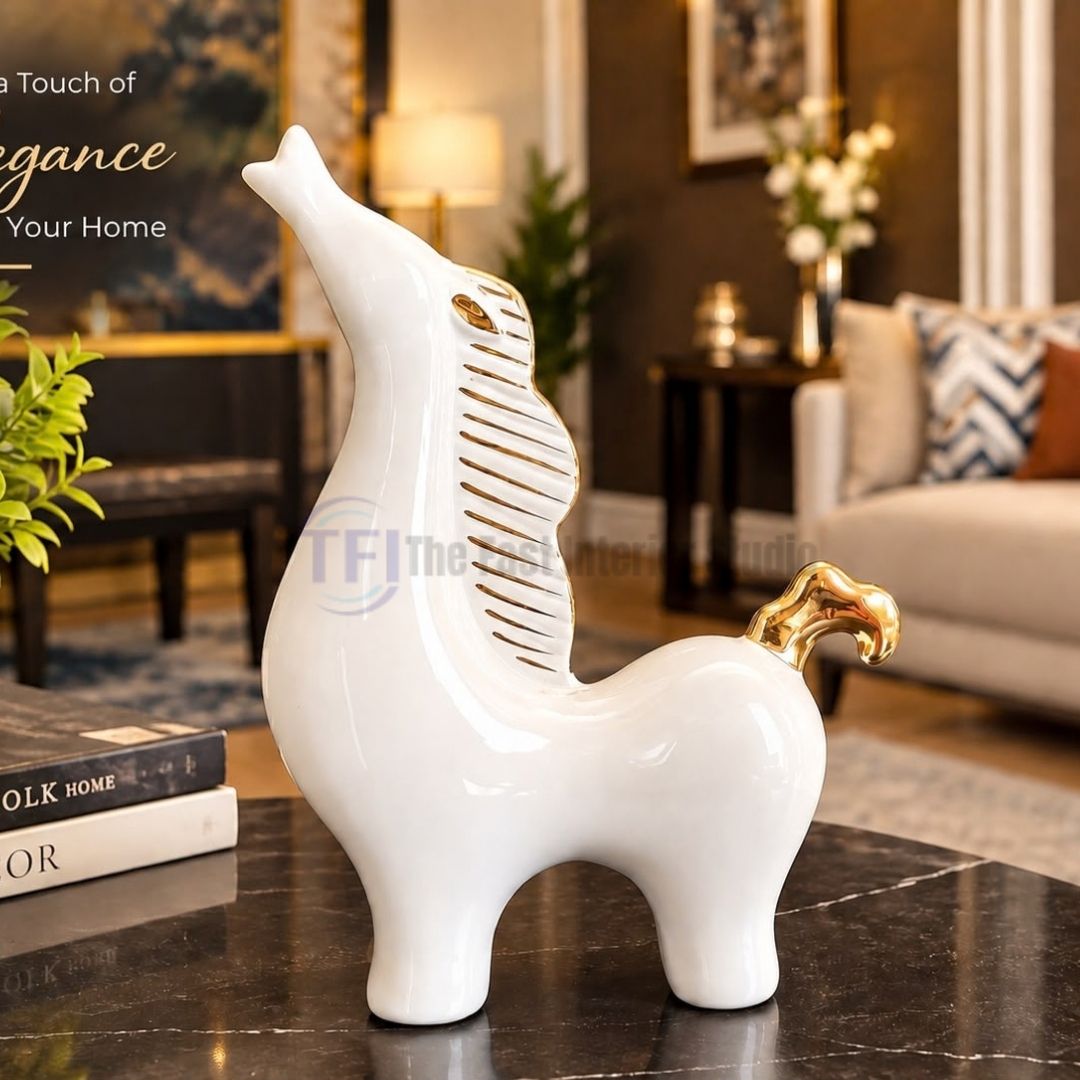 The best modern white and gold abstract horse sculpture styled next to decorative books on a marble table for versatile luxury decor