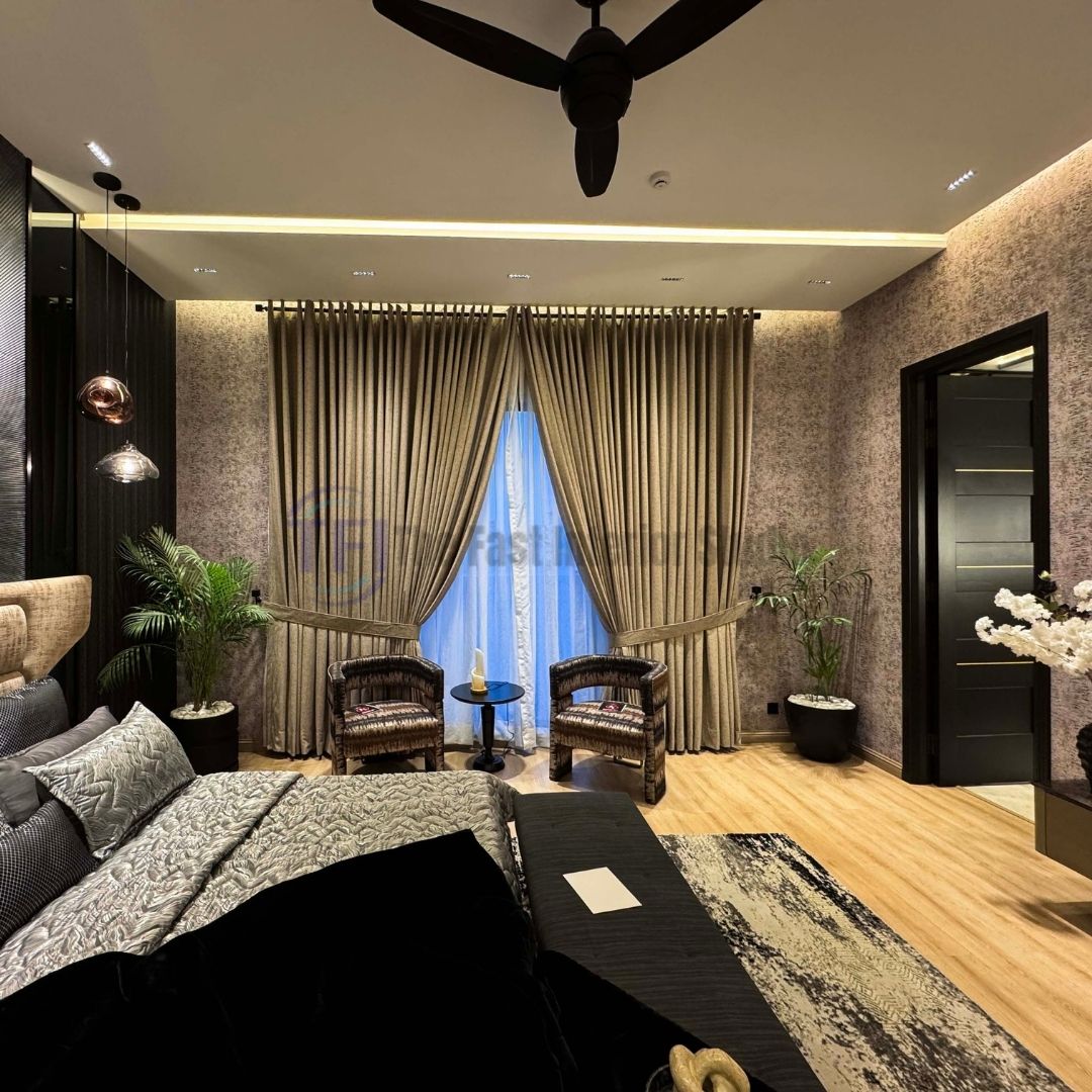 Tied-back gold curtains framing sheer white inner drapes in a modern bedroom