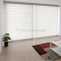 Trending crisp white Zebra blinds installed side-by-side on expansive living room windows in a modern Lahore home | The Fast Interior Studio