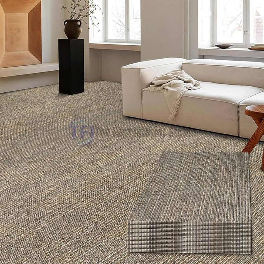Warm earth-toned textured carpet tiles with stacked squares complementing a luxury white sofa lounge