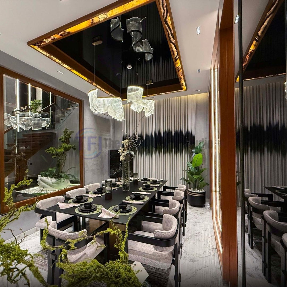 Wide view of a luxury dining room with abstract banded curtains and a modern wave chandelier