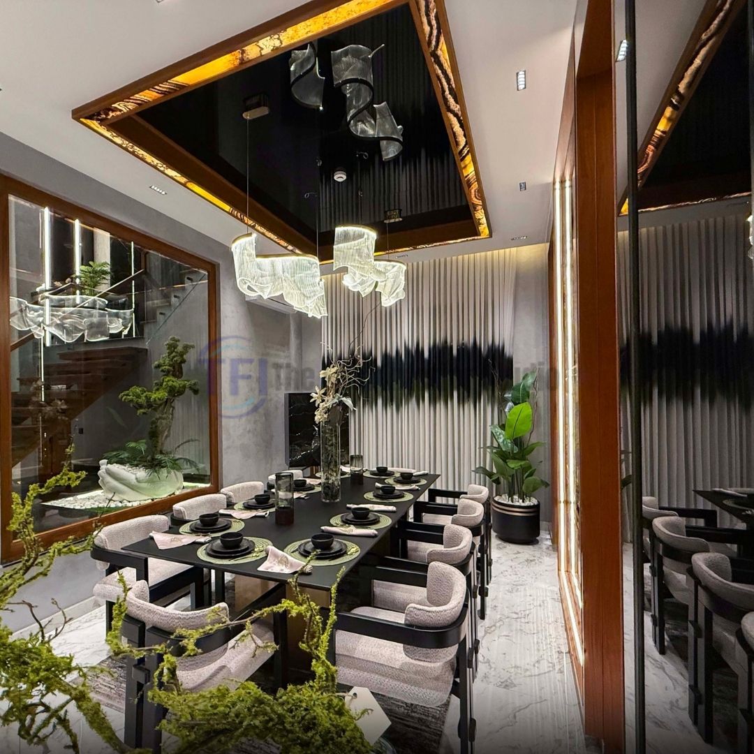 Wide view of a luxury dining room with abstract banded curtains and a modern wave chandelier