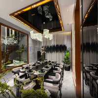 Wide view of a luxury dining room with abstract banded curtains and a modern wave chandelier