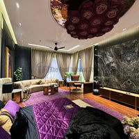 Wide view of luxury tied-back curtains in a grand bedroom suite with purple accents
