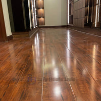 view of polished Chaina Floor 12 MM wooden flooring, beautifully reflecting vertical LED strip lights from modern wardrobe cabinets